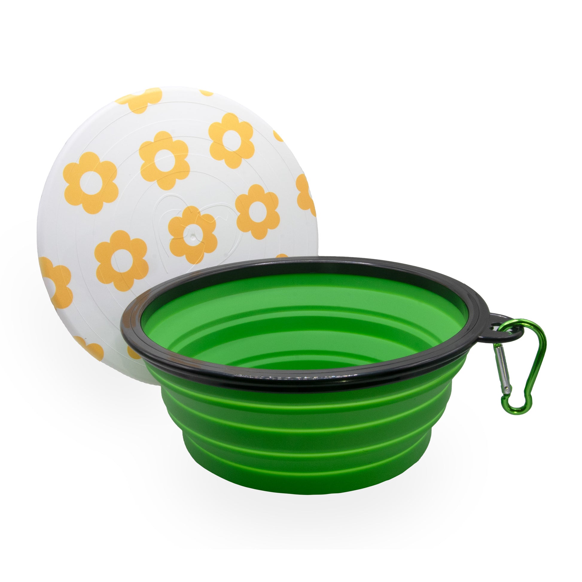 green collapsible bowl with a black rim and a clip, positioned in front of a white frisbee-like object adorned with yellow flower patterns