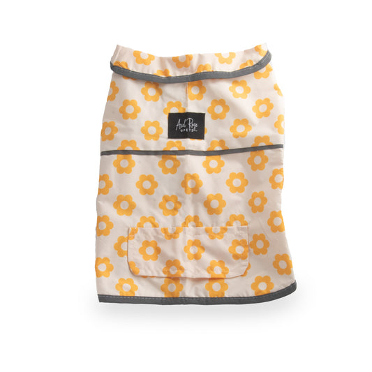 image shows a dog raincoat with a pattern of orange flowers on a white background. The raincoat has gray trim and a small pocket